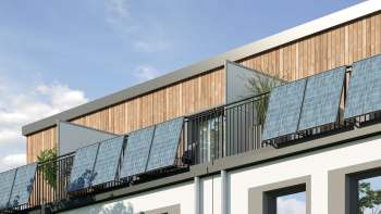 A building with solar panels on a balcony and wooden wall accents.