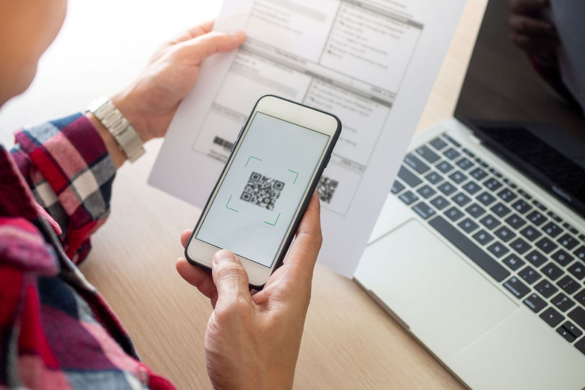 A person scans a QR code with a smartphone.