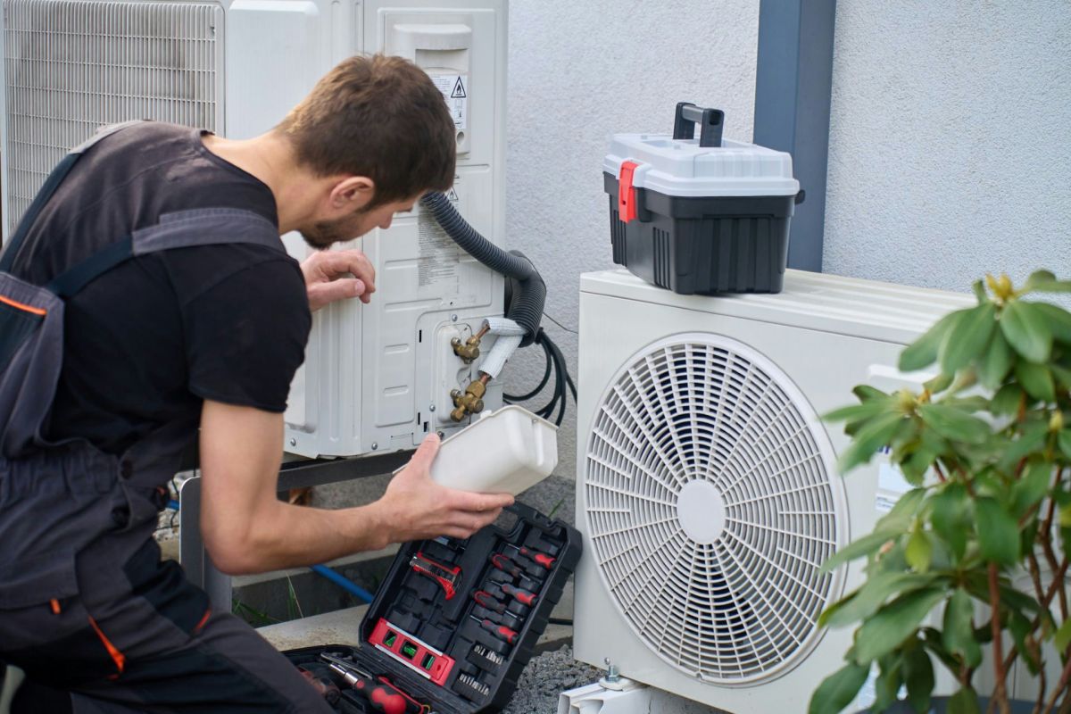A technician working on a heat pump.