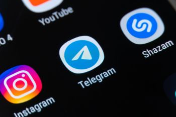 A smartphone screen displaying app icons, including Instagram, Telegram, YouTube, and Shazam.