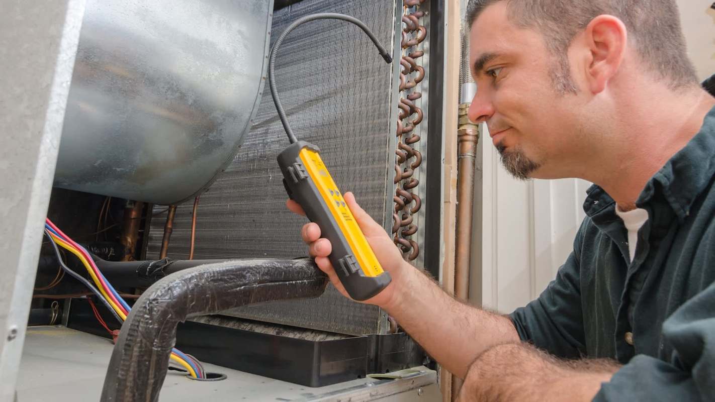 A technician uses a gas leak detector near an air conditioning unit.