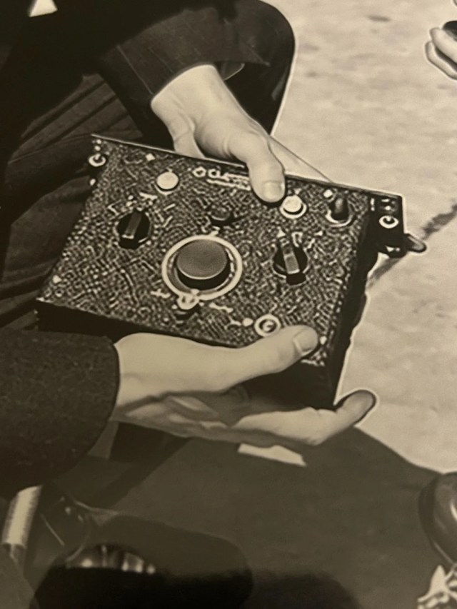 A person holding a radio.