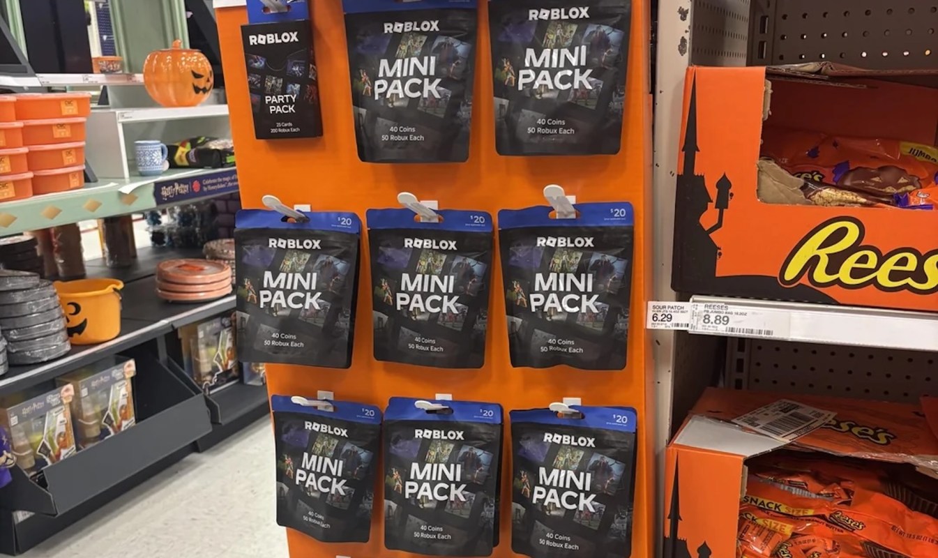 Roblox Mini Pack cards displayed on an orange backdrop alongside Halloween-themed items and candy.