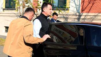 Erion Veliaj, mayor of Tirana, Albania, being escorted into a car.