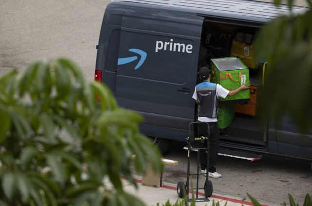 An Amazon worker with packages.