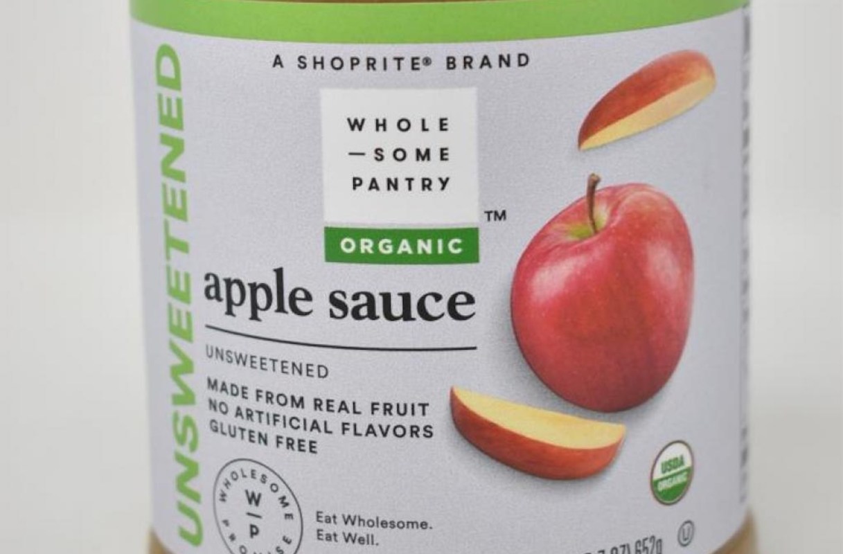 A jar of organic unsweetened apple sauce with an apple graphic and product details on the label.