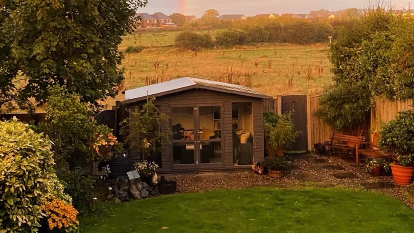 A house in front of an open field.