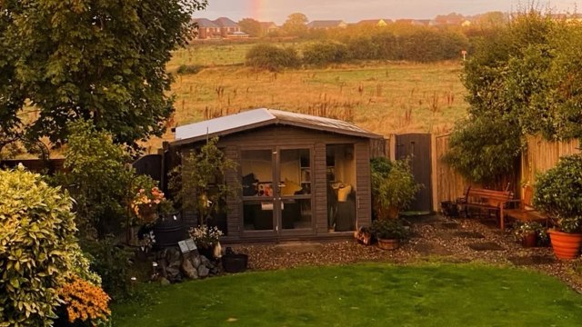 A house in front of an open field.