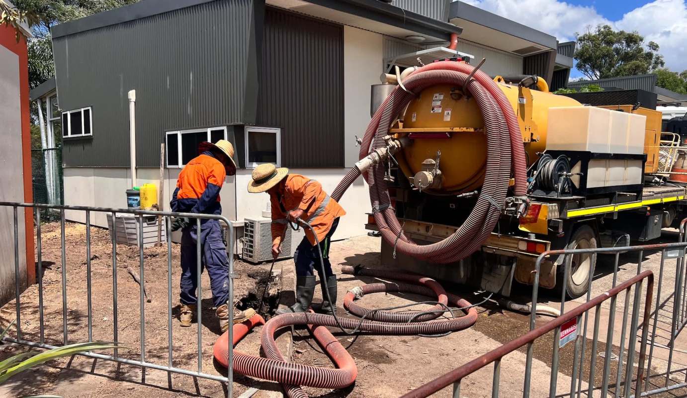 Workers emptying septic tanks.