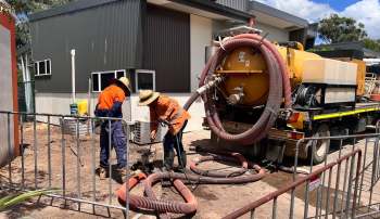 Workers emptying septic tanks.