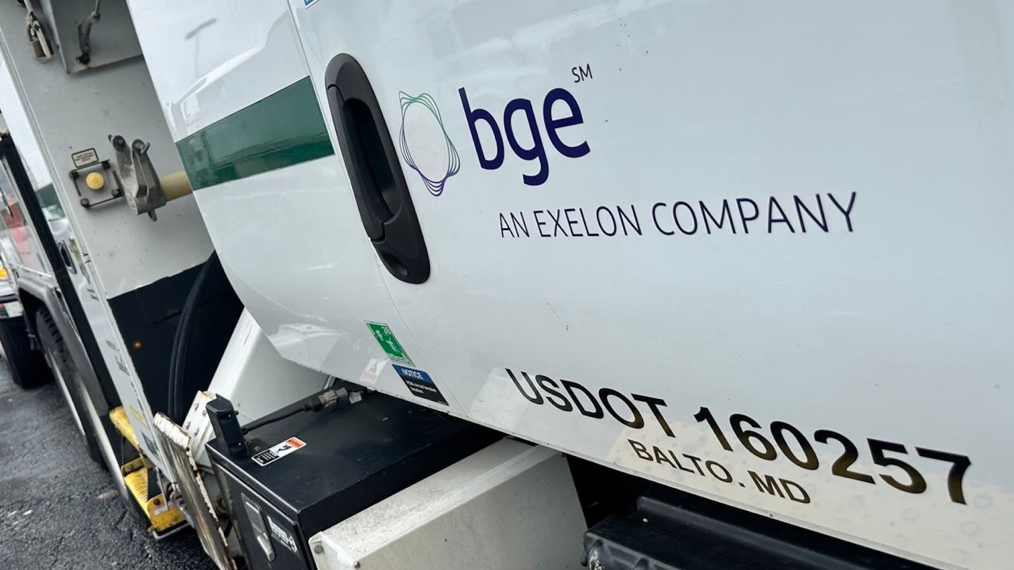 A logo and identification details on the side of a utility truck.