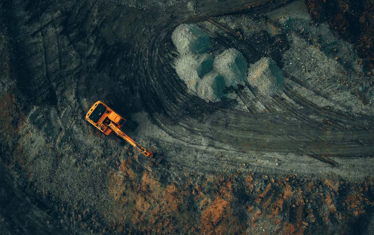 An orange excavator at work.