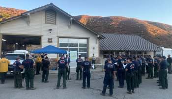 Firefighters outside a building.