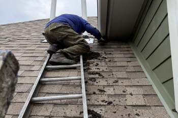A contractor fixing a roof.
