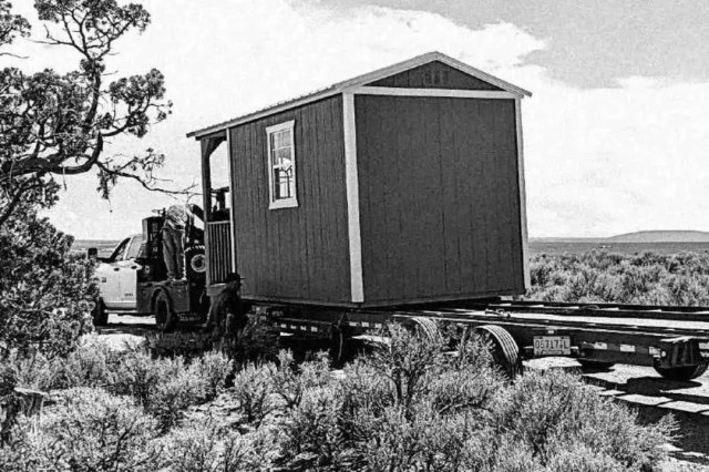 A shed being pulled on a trailer.