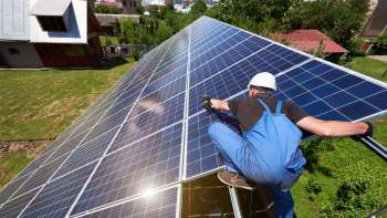 A worker installing solar panels.