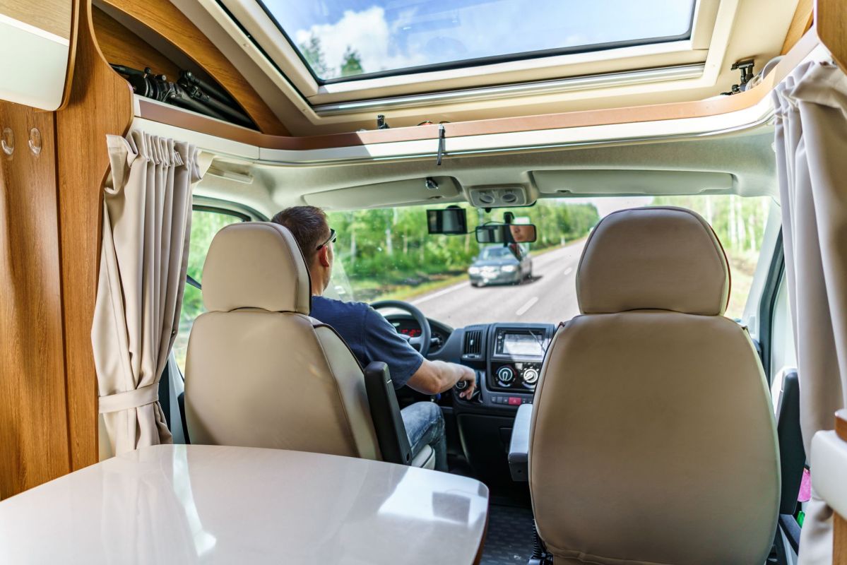 A person driving a camper van.