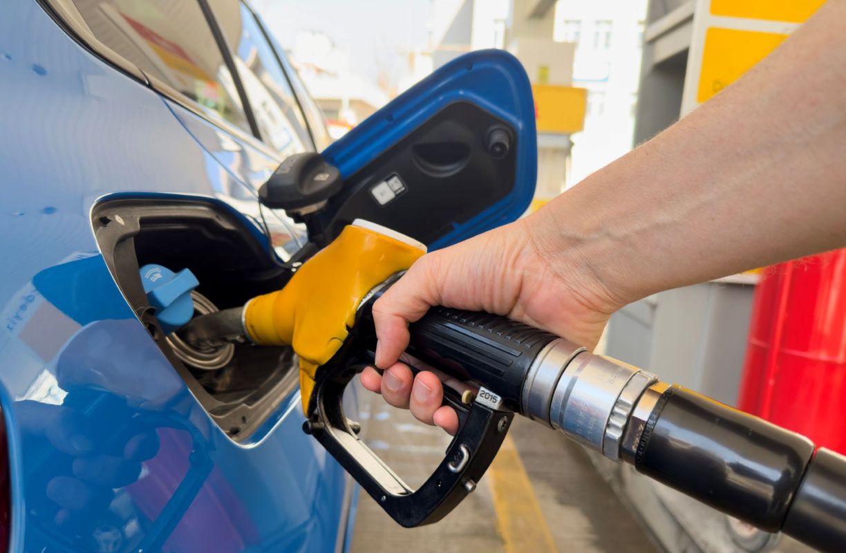 A person filling a car with gas.
