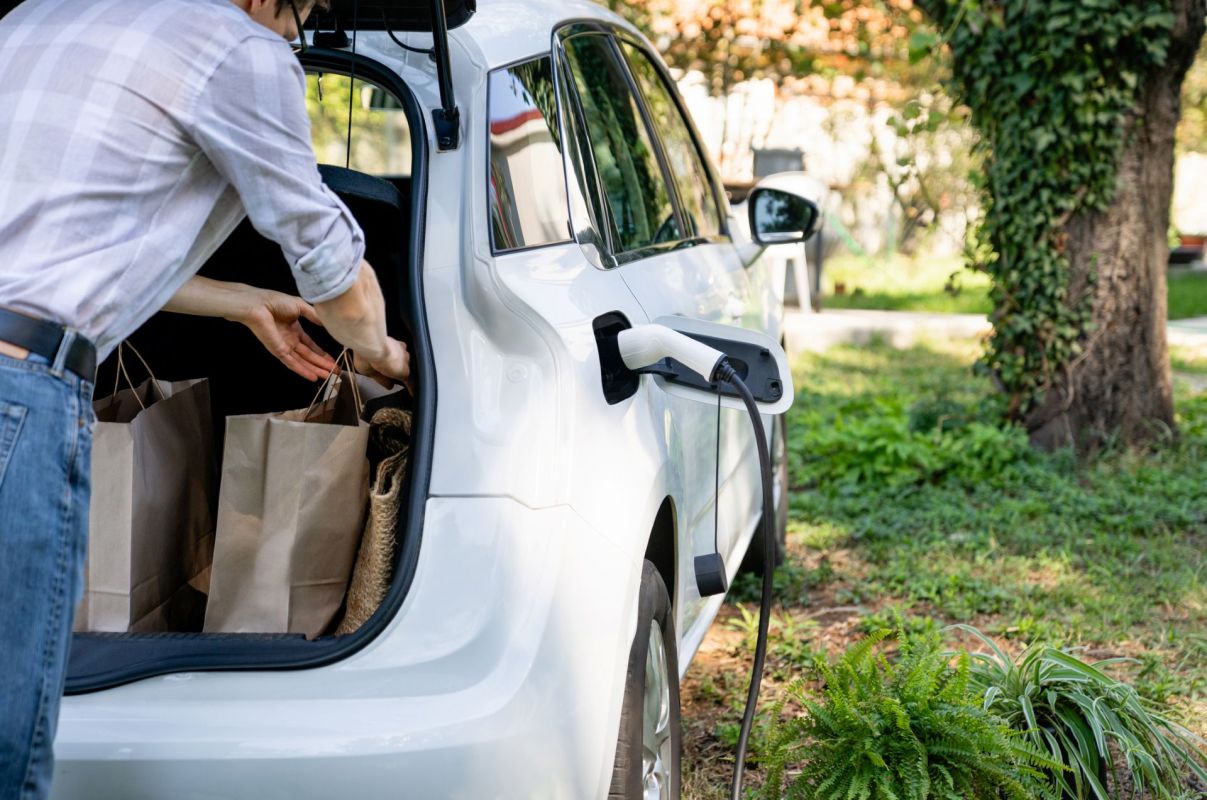 A person charging an EV.