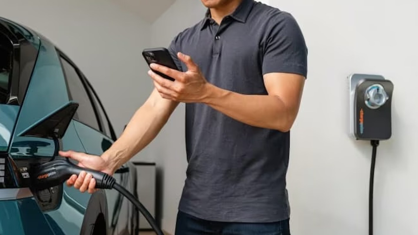 A person charging an EV.