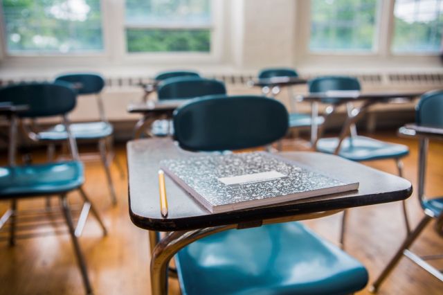 Empty school desks in a classroom.