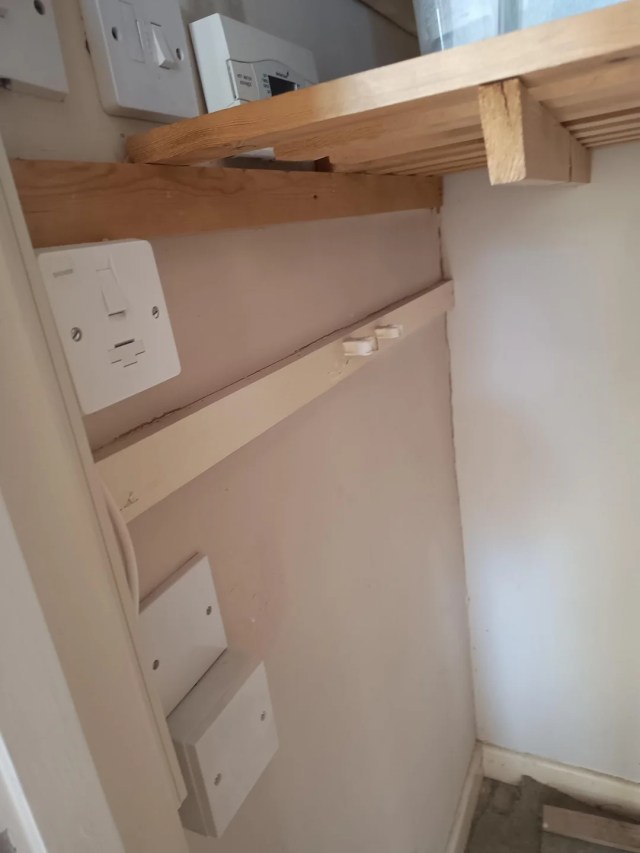 A cupboard with old boiler controls.