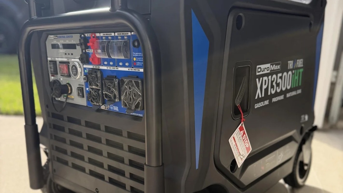A DuroMax tri-fuel generator with control panel and outlets.