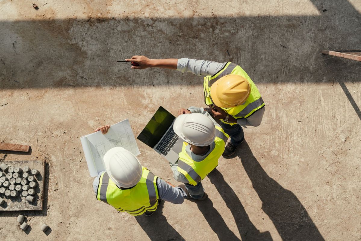 Three workers at a construction site.