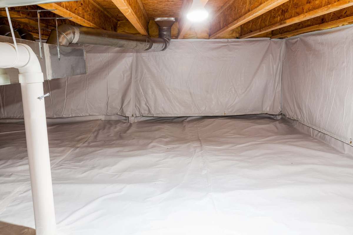 An indoor space with a white plastic vapor barrier, a pipe, and exposed wooden beams.