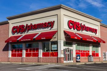 A CVS pharmacy building with red awnings and signage.