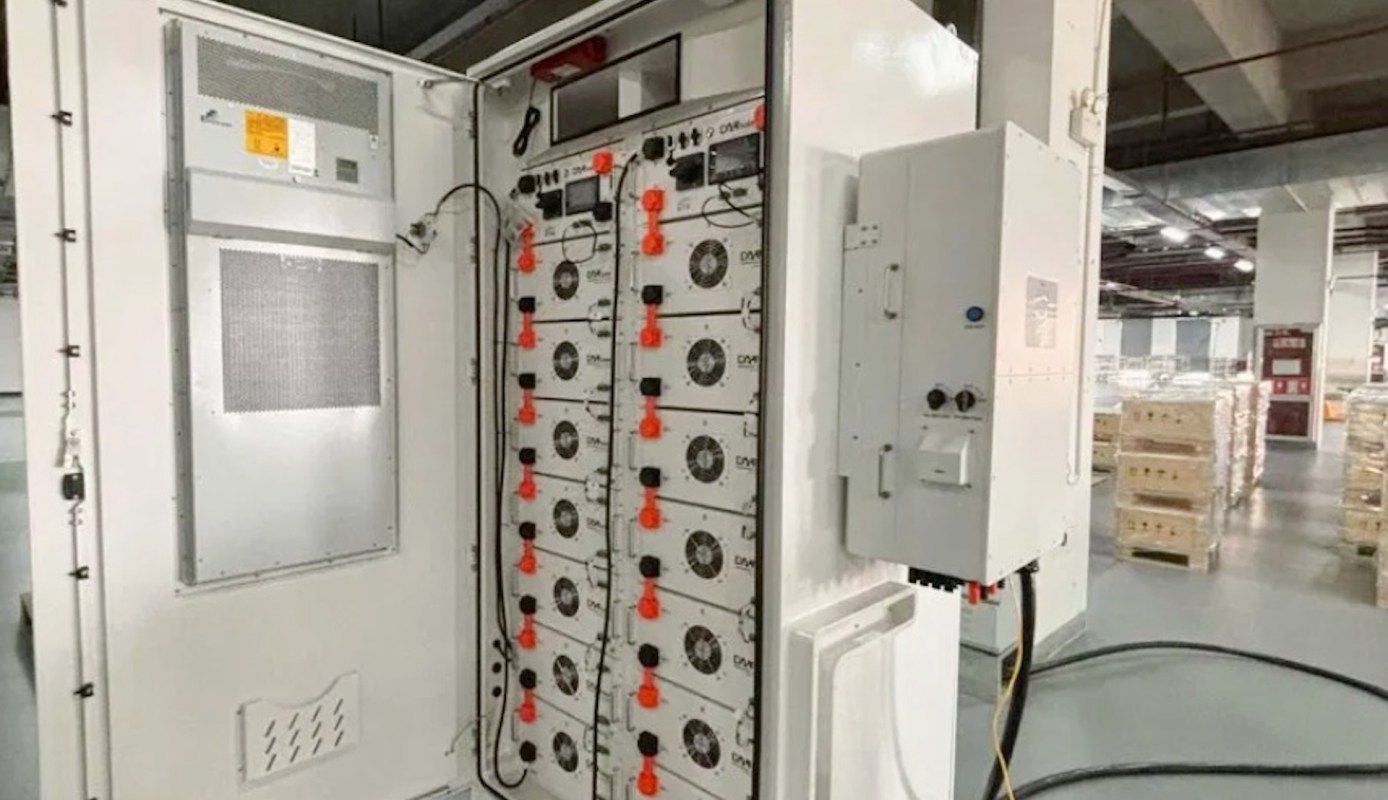 An industrial electrical panel with multiple components and wires in a warehouse setting.