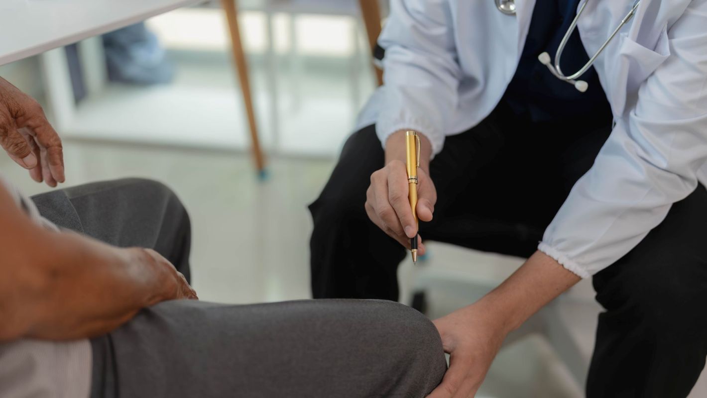 A doctor examining a patient's knee.