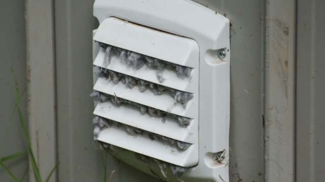 A vent covered in dust and lint.