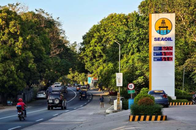 A sign for a petrol station in the Philippines.
