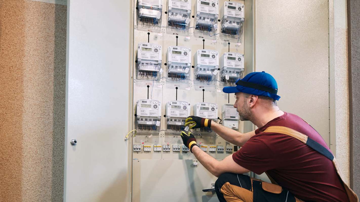 An electrician working on a utility panel.