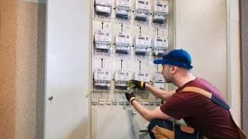 An electrician working on a utility panel.