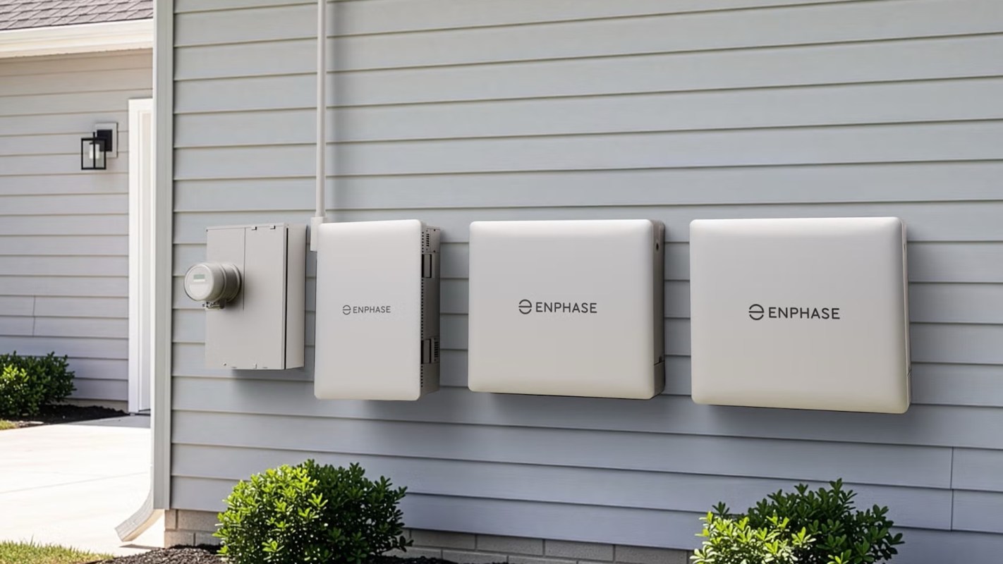 Electrical equipment, including meters and Enphase storage batteries, mounted on a house exterior.