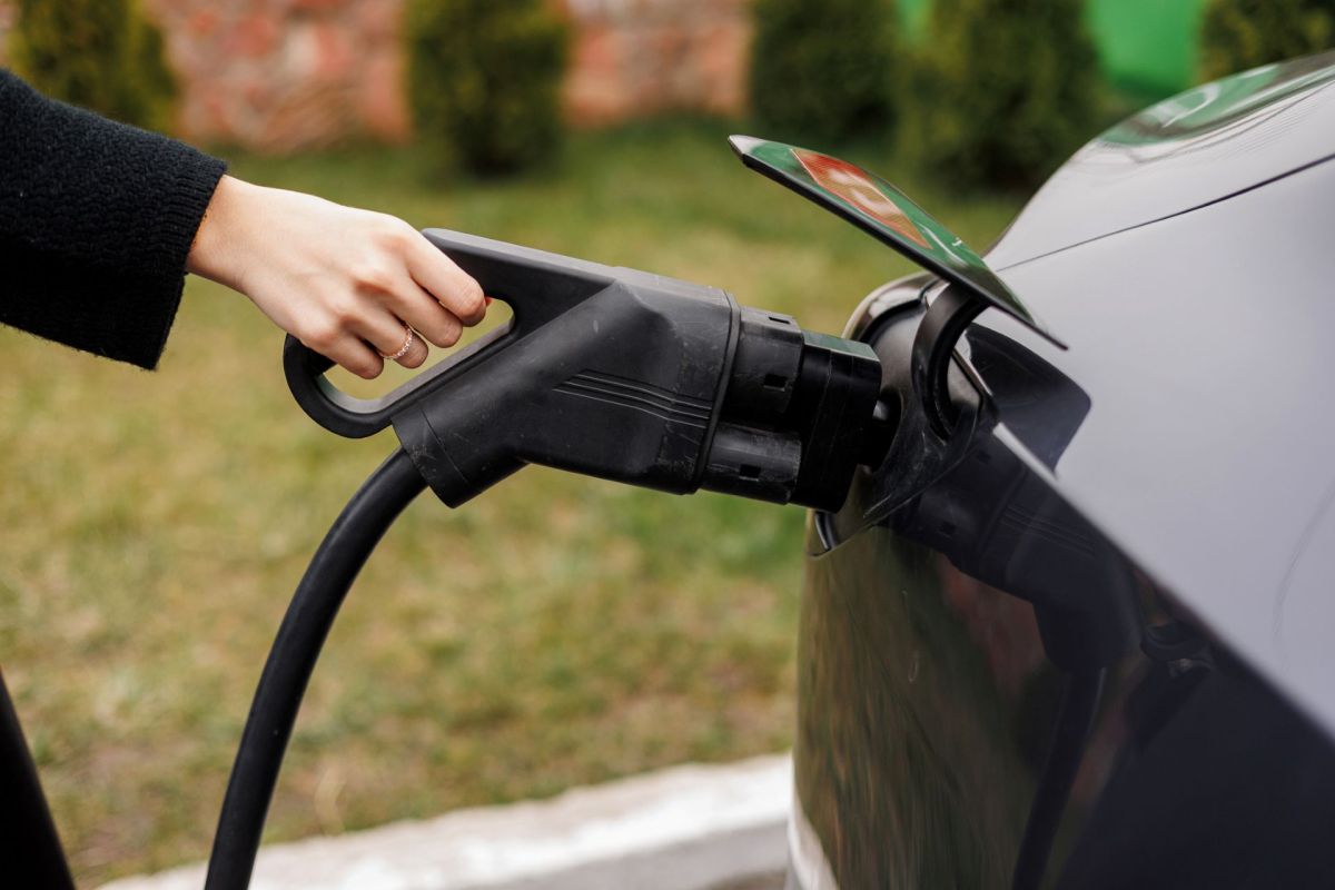A person charging an EV.