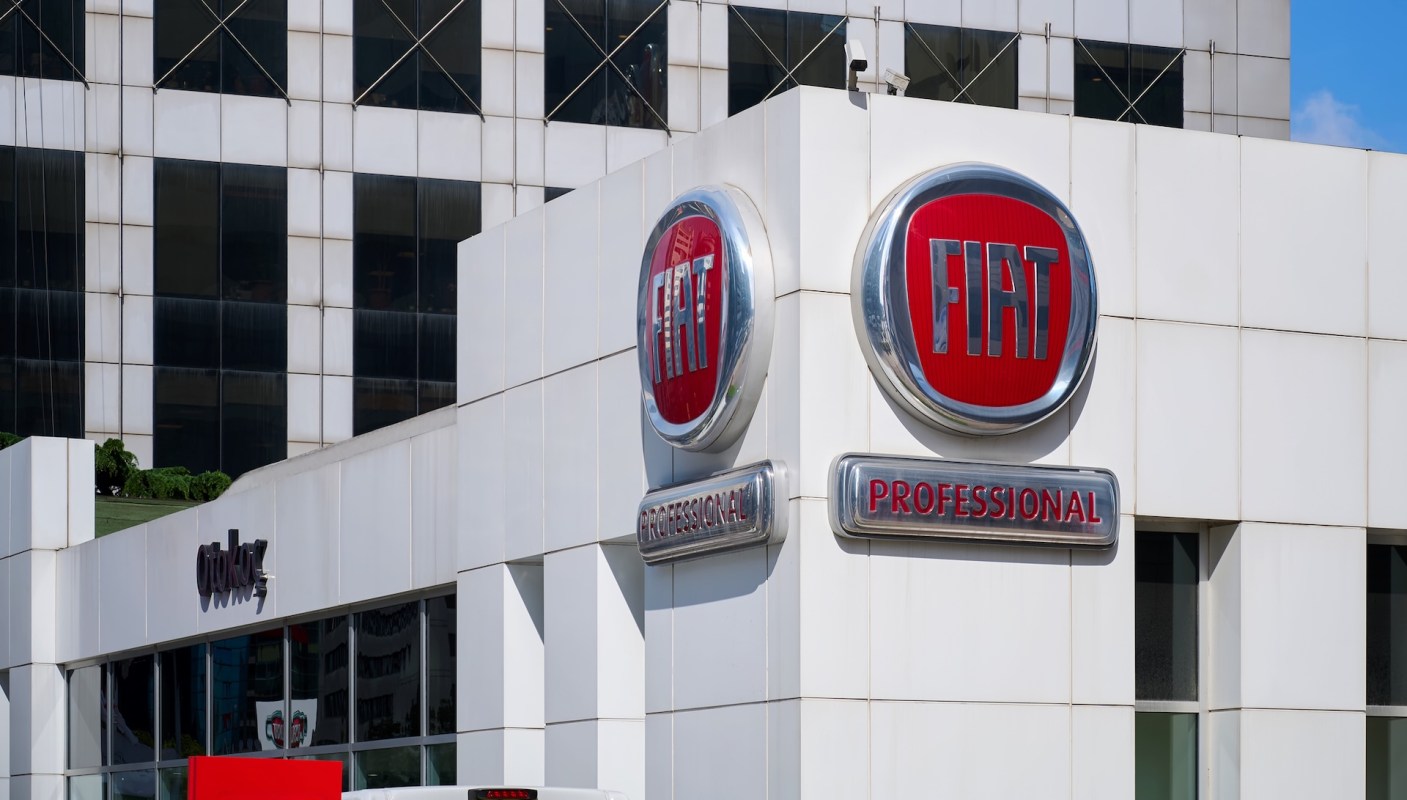 A Fiat dealership sign featuring the logo and "Professional" label on a modern building.