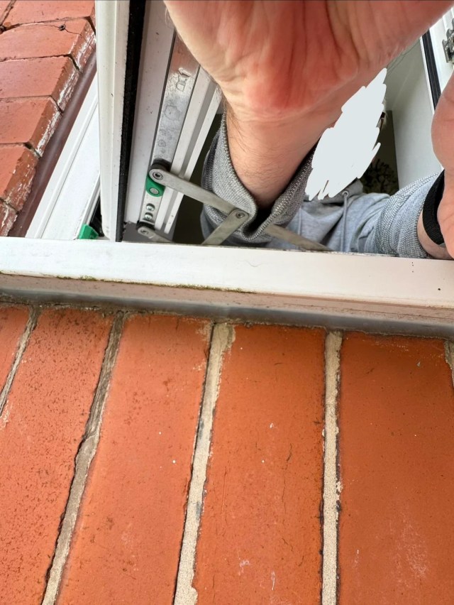 A hand sticking out a window.