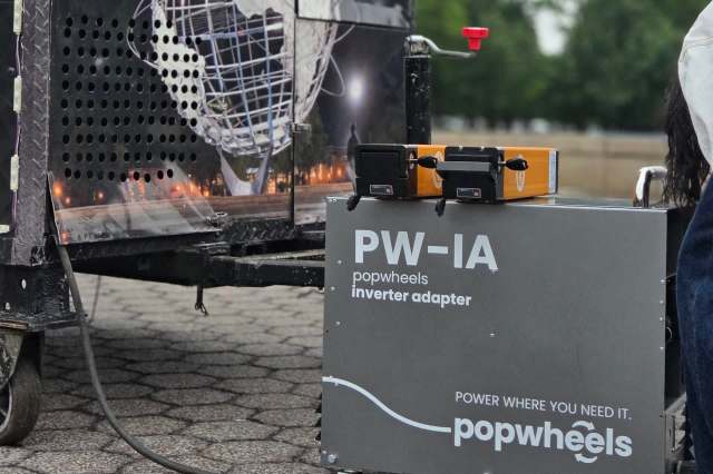 A PopWheels inverter adapter next to a food cart.