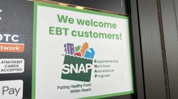 A sign welcoming EBT customers and advertising the SNAP program.