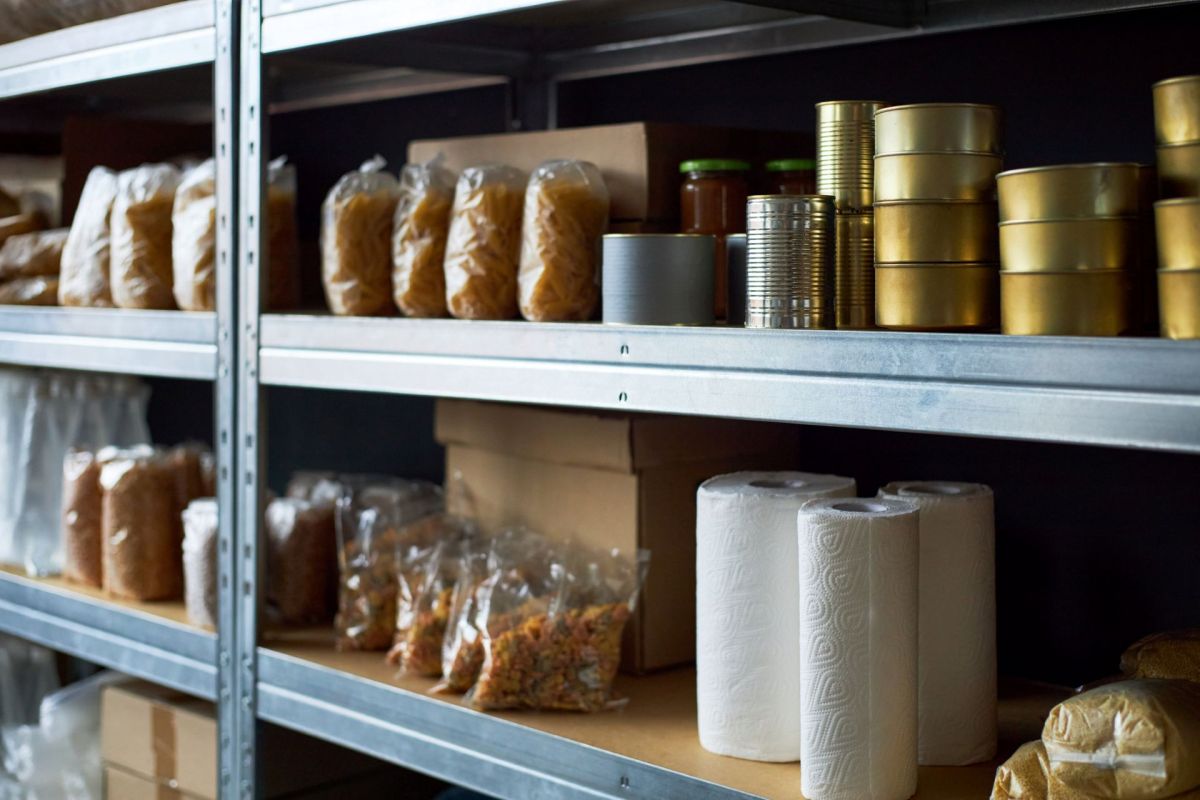 Food stored on shelves in a storeroom.