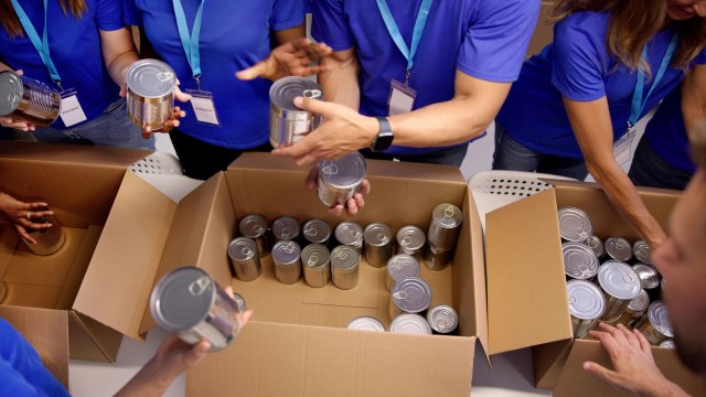 Volunteers sorting canned goods at a food bank.