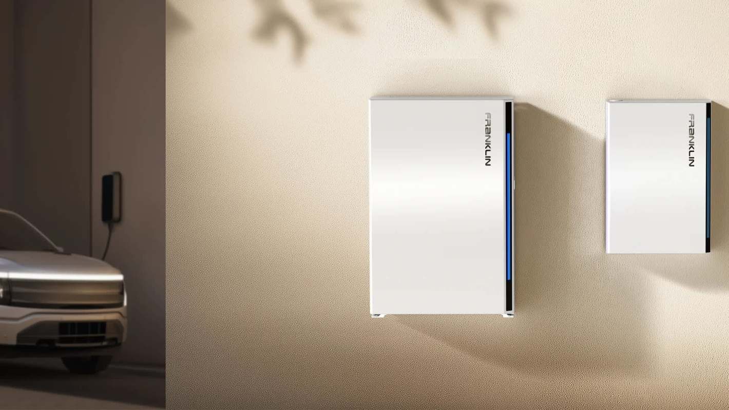 A white charging station and FranklinWH battery mounted on a textured wall beside an electric vehicle.