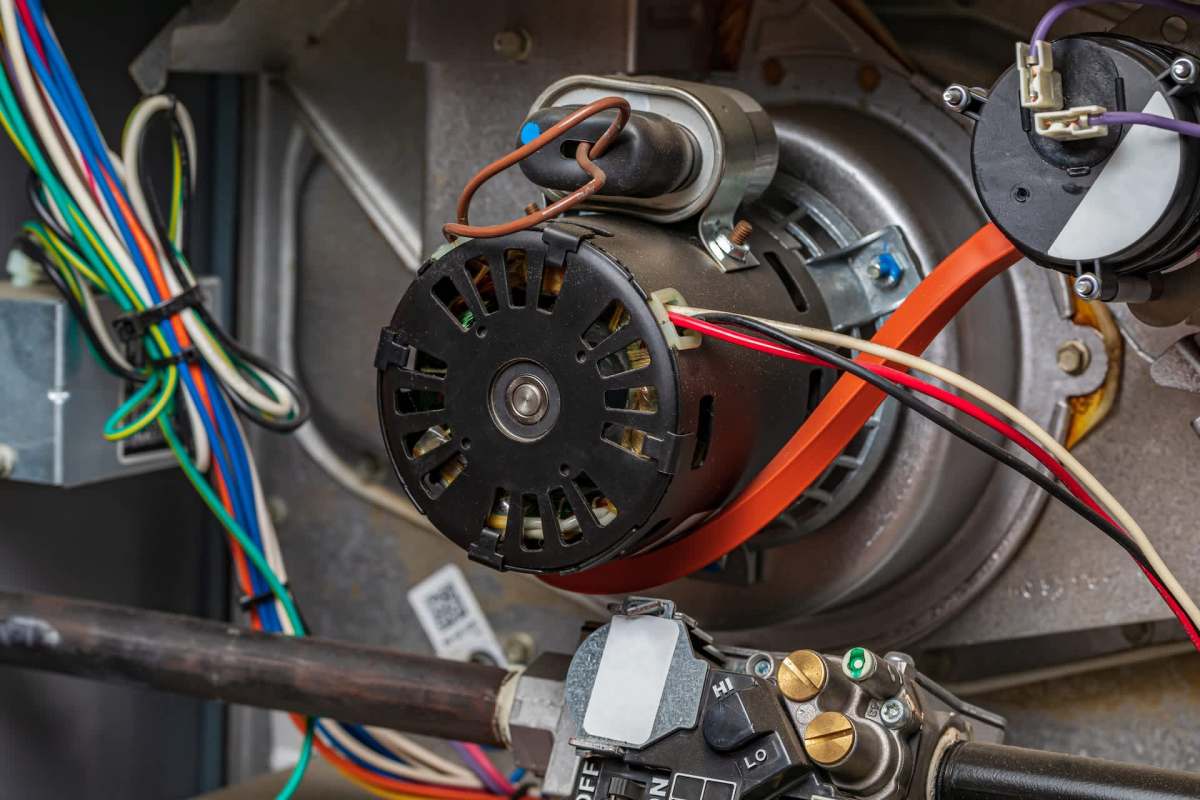 An electric motor with connected wires and a control panel inside a mechanical device.