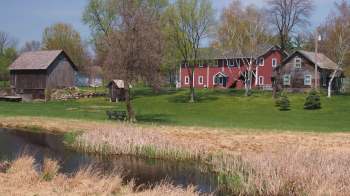 A red house and wooden barn at the Gammelgården Museum.