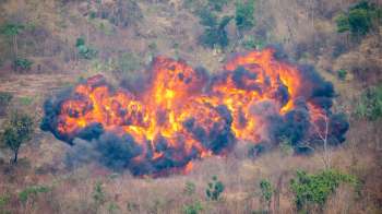 An explosion in a dry, grassy area.