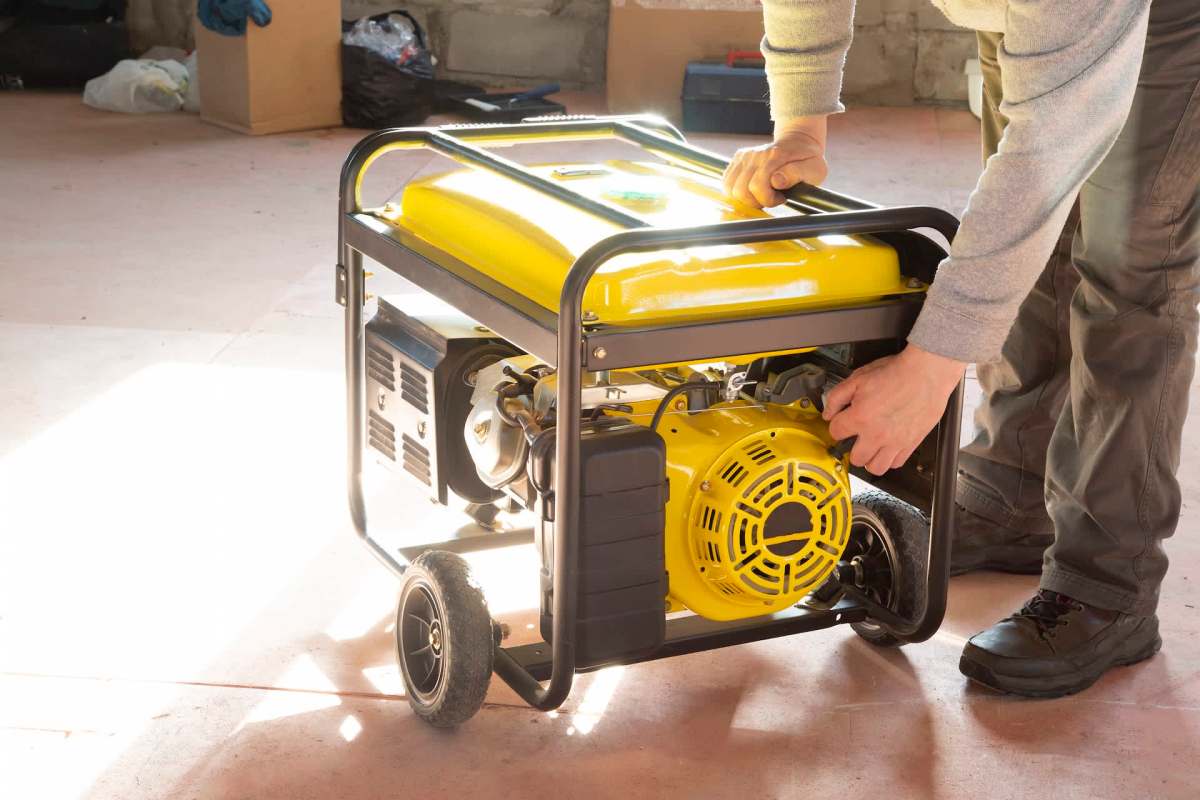 A person operating a yellow generator.