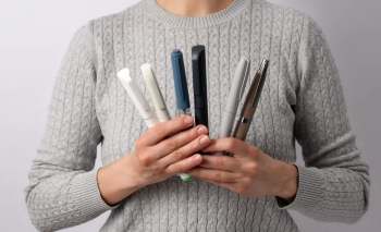 A person holding injection pens.